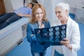 Cheerful delighted woman standing near the oncologist