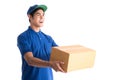 Cheerful delivery man. Happy young courier holding a cardboard box Royalty Free Stock Photo