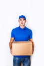 Cheerful delivery man. Happy young courier holding a cardboard box and smiling Royalty Free Stock Photo