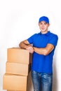 Cheerful delivery man. Happy young courier holding a cardboard box and smiling Royalty Free Stock Photo