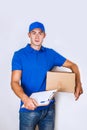 Cheerful delivery man. Happy young courier holding a cardboard box and smiling Royalty Free Stock Photo