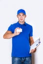 Cheerful delivery man. Happy young courier holding a cardboard box and smiling Royalty Free Stock Photo