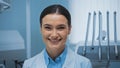 cheerful dentist smiling at camera near