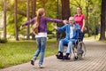 Cheerful disabled grandfather enjoying with his granddaughter an