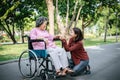 Cheerful disabled grandfather in wheelchair welcoming his happy Royalty Free Stock Photo