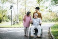 Cheerful disabled grandfather in wheelchair welcoming his happy Royalty Free Stock Photo