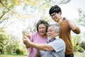 Cheerful disabled grandfather in wheelchair welcoming his happy Royalty Free Stock Photo