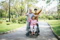 Cheerful disabled grandfather in wheelchair welcoming his happy Royalty Free Stock Photo