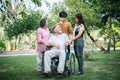 Cheerful disabled grandfather in wheelchair welcoming his happy Royalty Free Stock Photo