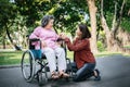 Cheerful disabled grandfather in wheelchair welcoming his happy Royalty Free Stock Photo