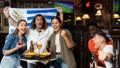 Cheerful diverse football fans waving flag of Uruguay and drinking beer, eating chips in the bar Royalty Free Stock Photo