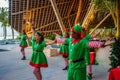 Cheerful diversity male and female group of christmas elves performing dance during celebration party