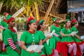 Cheerful diversity male and female group of christmas elves singing song during celebration party