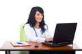 Cheerful doctor woman using laptop