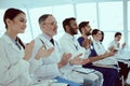 Cheerful doctors clapping hands during conference in clinic Royalty Free Stock Photo