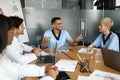 Cheerful doctors multiracial team having breefing, discussing cases Royalty Free Stock Photo