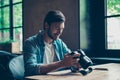 Cheerful dreamy brunet hipster traveller is watching his shoots