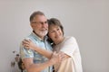 Cheerful dreamy older 60s married couple hugging with love, care Royalty Free Stock Photo