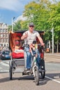 Cheerful driver on his awesome bike taxi, Amsterdam, netherlands