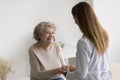 Cheerful elderly 80s patient woman visiting empathetic doctor