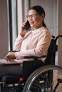 Cheerful elegant female with disability talking on phone Royalty Free Stock Photo