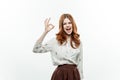 cheerful elegant woman gesturing with hand formal suit light background