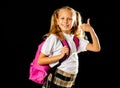 Cheerful elementary schoolgirl in uniform holding a big pink backpack Royalty Free Stock Photo