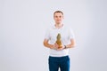 Cheerful and emotional guy holding a pineapple in his hand on a white background Royalty Free Stock Photo