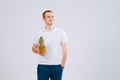 Cheerful and emotional guy holding a pineapple in his hand on a white background Royalty Free Stock Photo