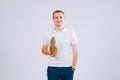 Cheerful and emotional guy holding a pineapple in his hand on a white background Royalty Free Stock Photo