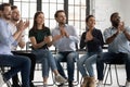 Cheerful employees clap hands encourage business coach start workshop