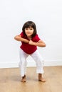 Cheerful energetic young child expressing dynamic body language and motivation