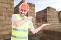 Cheerful engineer holding something in his palm