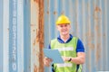 Cheerful engineer man in hard hat smiling and looking at camera with holding clipboard checklist