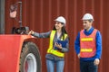 Cheerful engineers team managing cargo operations, Engineer and foreman worker checking containers box at shipping yard Royalty Free Stock Photo