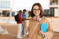 Cheerful european millennial woman in casual and glasses with coffee cup ready for study