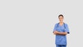 Cheerful european nurse in blue scrubs with crossed arms and a stethoscope Royalty Free Stock Photo