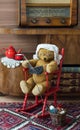 Teddy bear grandma knitting in a rocking chair in a vintage interior