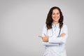 Cheerful european woman doctor pointing finger aside at free space advertising medical ad, banner Royalty Free Stock Photo