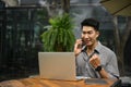 Cheerful and excited Asian businessman rejoicing while talking on the phone Royalty Free Stock Photo