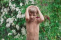 Cheerful, excited baby having fun, running wet under rain