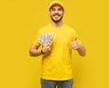 Cheerful excited ecstatic overjoyed man throwing money away showing his wealthiness isolated Royalty Free Stock Photo