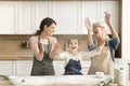 Cheerful excited kid girl, mom and grandma throwing flour powder Royalty Free Stock Photo