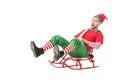 cheerful excited man in christmas elf costume riding sleigh isolated