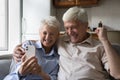 Cheerful excited senior couple surprised with good surprising news