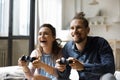 Cheerful excited young couple playing virtual video games Royalty Free Stock Photo