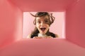 Cheerful and excited young girl looking inside carton box. Looking extremely happy Royalty Free Stock Photo