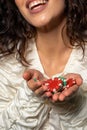 Cheerful excited young woman holding pile of betting chips