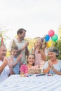 Cheerful extended family clapping for little girls birthday