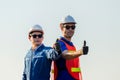 Cheerful factory worker and engineer man smiling with giving thumbs up as sign of Success Royalty Free Stock Photo